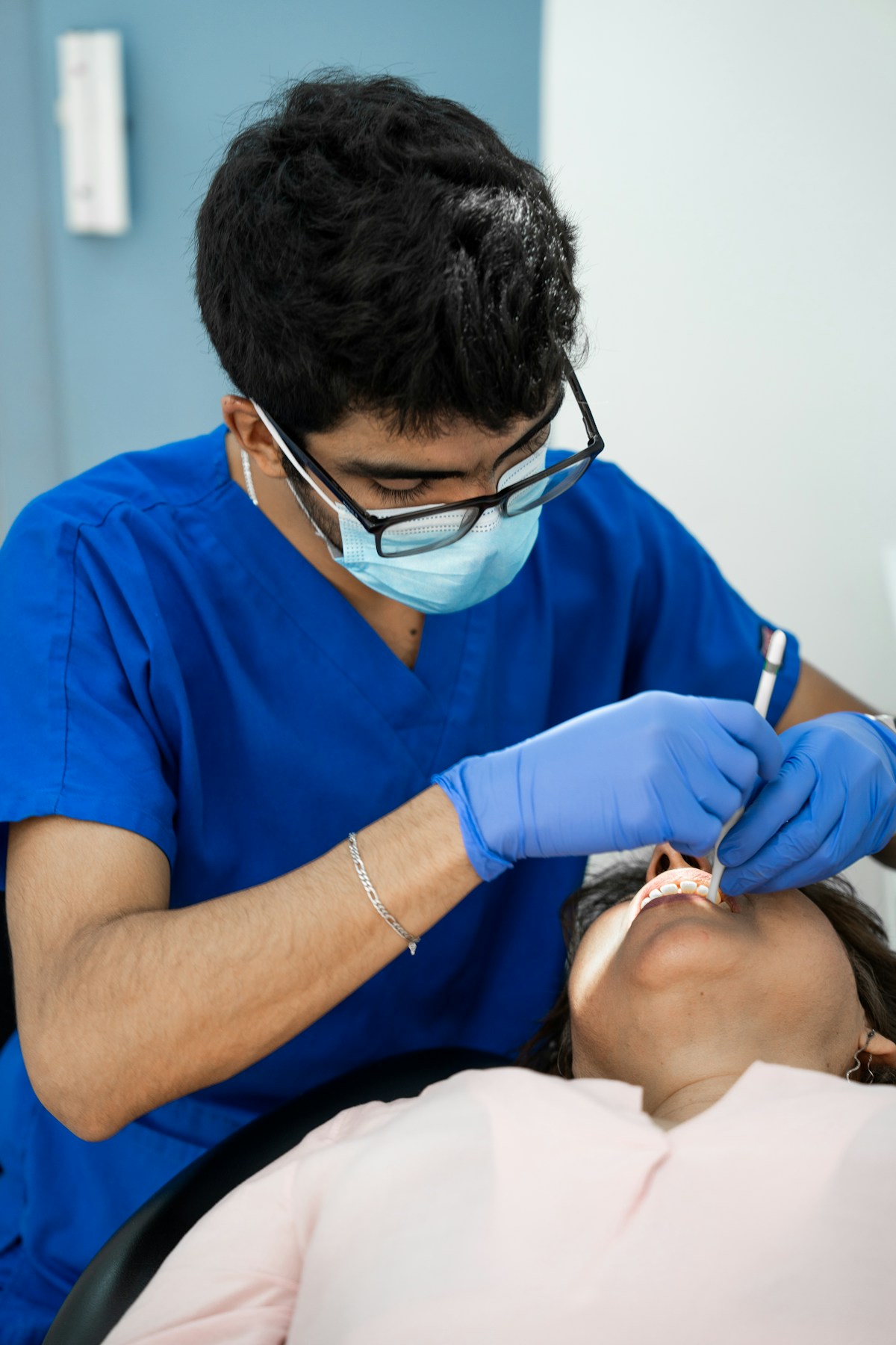 Dentist examining a patient during a restorative care visit